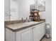 Bathroom showcasing a well-lit vanity with a storage cabinet and a neatly organized shelf at 547 Windsor Pl, Davenport, FL 33896
