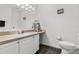 Bathroom boasting a vanity with ample storage, a toilet, and a stylish mirror at 547 Windsor Pl, Davenport, FL 33896