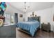 Bedroom featuring tray ceiling, dark wood floors, a dresser, and a ceiling fan at 547 Windsor Pl, Davenport, FL 33896