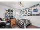 Cozy bedroom decorated with racing memorabilia, complete with ceiling fan and natural light at 547 Windsor Pl, Davenport, FL 33896