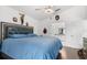 This primary bedroom has dark wood floors and modern decor at 547 Windsor Pl, Davenport, FL 33896