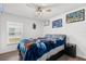 Welcoming bedroom with a ceiling fan, natural light, and a comfortable bed at 547 Windsor Pl, Davenport, FL 33896