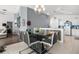 Dining area with a modern table, a view into the living room, and seamless access to the kitchen at 547 Windsor Pl, Davenport, FL 33896
