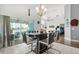 Bright dining room featuring a modern table set with a view of the outdoor patio at 547 Windsor Pl, Davenport, FL 33896
