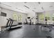 Well-equipped gym with treadmills, elliptical machines, weights, and TVs for a complete workout at 547 Windsor Pl, Davenport, FL 33896