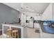 Bright kitchen features an island with bar seating, white cabinets, and stainless steel appliances at 547 Windsor Pl, Davenport, FL 33896