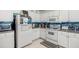 This kitchen has stainless appliances, a tile backsplash, and lots of storage space at 547 Windsor Pl, Davenport, FL 33896