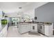Open-concept kitchen featuring white cabinets, stainless appliances, and a view to outdoor living space at 547 Windsor Pl, Davenport, FL 33896