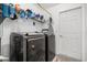 Organized laundry room with front loading washer and dryer, shelving, and ample storage space at 547 Windsor Pl, Davenport, FL 33896