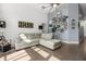 Cozy living room featuring a comfortable sofa, high ceilings, and decoratively framed pictures on the wall at 547 Windsor Pl, Davenport, FL 33896