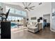 Spacious living room with hardwood floors, high ceilings, a large fan, and sliding glass doors to the pool at 547 Windsor Pl, Davenport, FL 33896