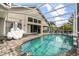 Inviting screened-in pool area with ample seating and outdoor living space at 547 Windsor Pl, Davenport, FL 33896