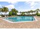 Beautiful community pool with surrounding lounge chairs and palm trees at 547 Windsor Pl, Davenport, FL 33896