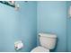 A standard toilet in a blue tiled bathroom setting at 547 Windsor Pl, Davenport, FL 33896