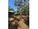 Backyard view of a cozy home featuring a deck and a shaded carport with ample space at 4266 County Road 691, Webster, FL 33597