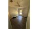 Empty bedroom featuring wood floors, natural light from a window, and shelves for storage at 4266 County Road 691, Webster, FL 33597