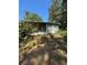 Exterior view of an enclosed porch on a sunny day with trees and grass at 4266 County Road 691, Webster, FL 33597