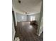 Cozy living room featuring wood floors, a ceiling fan, and natural light from the windows at 4266 County Road 691, Webster, FL 33597