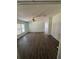 Large open living room featuring wood-style flooring and natural light from the large window at 4266 County Road 691, Webster, FL 33597