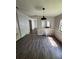 Open-concept living area featuring new flooring, natural light, and a simple pendant light at 4266 County Road 691, Webster, FL 33597