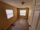Bedroom featuring neutral colored walls, small window, and door with brass-colored hardware at 206 W 9Th St, Lakeland, FL 33805