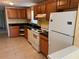 Functional kitchen featuring classic white appliances and dark countertops at 206 W 9Th St, Lakeland, FL 33805