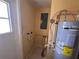 Dedicated laundry room with modern water heater and tile flooring at 206 W 9Th St, Lakeland, FL 33805