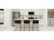 Bright, modern kitchen featuring white cabinets, stainless steel appliances, and a center island with seating at 3019 Totem Rd, Eagle Lake, FL 33839
