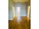 Bedroom featuring hardwood floors, neutral walls, and entry to the bathroom at 208 Shepard Ave, Dundee, FL 33838
