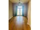 Light-filled bedroom with hardwood floors, French doors, and calming decor at 208 Shepard Ave, Dundee, FL 33838