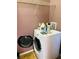 Clean laundry room with modern appliances and shelving perfect for simple household work at 208 Shepard Ave, Dundee, FL 33838