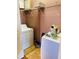 Functional laundry area equipped with washer, dryer, and wire shelving for organized household tasks at 208 Shepard Ave, Dundee, FL 33838