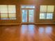 Open living area with hardwood floors, natural lighting, and a serene ambiance at 208 Shepard Ave, Dundee, FL 33838