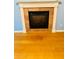 Close up of fireplace with stone surround and white mantel in cozy living room at 208 Shepard Ave, Dundee, FL 33838