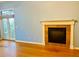 Cozy living room showcasing fireplace with stone surround and French door exterior access at 208 Shepard Ave, Dundee, FL 33838