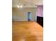 Spacious living room featuring hardwood floors, a ceiling fan, and neutral paint at 208 Shepard Ave, Dundee, FL 33838