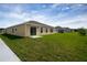 Expansive backyard featuring a lush green lawn and a sliding door leading to the patio at 2103 Forage Dr, Kissimmee, FL 34746
