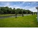 Serene backyard view of a canal surrounded by lush greenery and mature trees at 2103 Forage Dr, Kissimmee, FL 34746