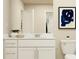 Clean bathroom features a white vanity, large mirror, and modern fixtures, providing a fresh and inviting space at 2103 Forage Dr, Kissimmee, FL 34746