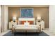 Inviting bedroom features an upholstered bench, paired lamps, and neutral decor for a relaxing, stylish space at 2103 Forage Dr, Kissimmee, FL 34746