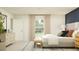 Bright bedroom featuring neutral bedding and an upholstered bench offers a serene and inviting atmosphere at 2103 Forage Dr, Kissimmee, FL 34746
