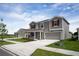 Exterior elevation of a two-story home featuring red shutters and a well-manicured lawn at 2103 Forage Dr, Kissimmee, FL 34746