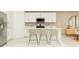 Modern kitchen with white cabinetry, stainless steel appliances, and an island that offers seating for three at 2103 Forage Dr, Kissimmee, FL 34746