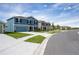 Street view showcases newly constructed homes with vibrant siding and landscaping, offering a fresh community appeal at 2103 Forage Dr, Kissimmee, FL 34746