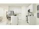 Bright kitchen features white cabinetry, stainless steel appliances, island with seating, and open layout at 2109 Forage Dr, Kissimmee, FL 34746