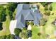 Aerial view of a luxury home with a pool, well-maintained landscaping, and a large driveway for multiple vehicles at 2660 Wyndsor Oaks Way, Winter Haven, FL 33884