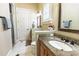 Tidy bathroom featuring granite countertops, single vanity, and decorative mirror at 2660 Wyndsor Oaks Way, Winter Haven, FL 33884