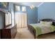 Bedroom featuring blue walls, carpeted floor, natural light, and a chandelier at 2660 Wyndsor Oaks Way, Winter Haven, FL 33884