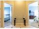 Bright hallway featuring decorative table and open doorways to the bedrooms on either side at 2660 Wyndsor Oaks Way, Winter Haven, FL 33884