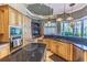 Gourmet kitchen boasts granite countertops, custom cabinetry, stainless steel appliances, and open layout at 2660 Wyndsor Oaks Way, Winter Haven, FL 33884
